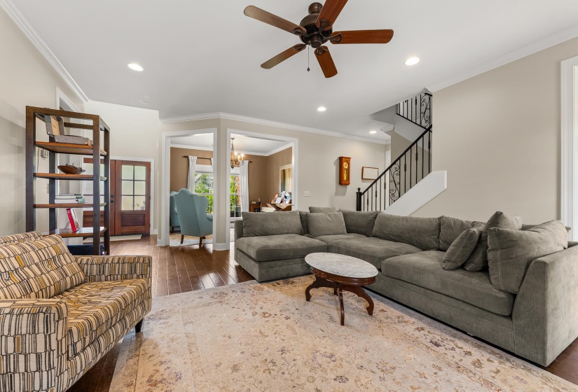 Spacious living area featuring wood-finish flooring, recessed lighting, and a ceiling fan