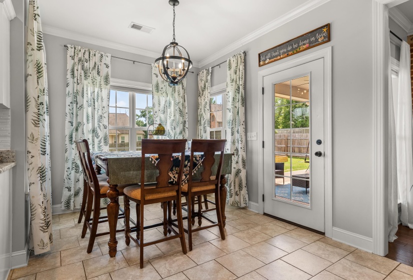 Dining area featuring tile flooring, a multi-pane glass door, and a decorative orb chandelier