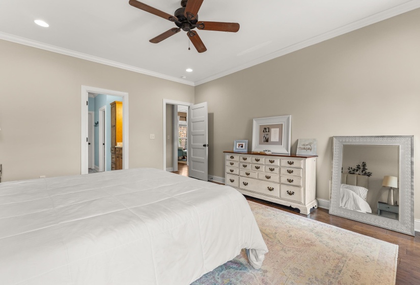 Neutral-toned room featuring a ceiling fan with integrated lighting, recessed lighting, crown molding, and wood-finish flooring