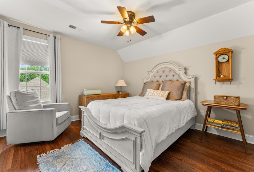 Interior room featuring rich wood-finish flooring and neutral wall tones