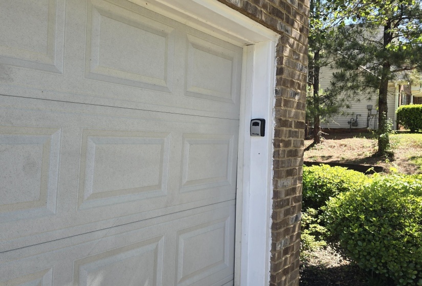Panel-style garage door with a brick exterior