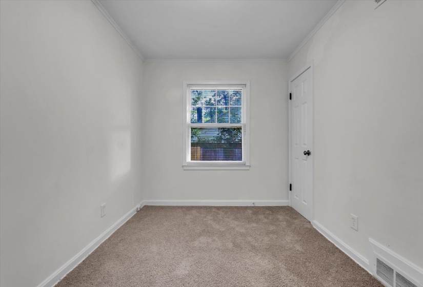 Neutral-toned carpeting paired with light-colored walls and white trim