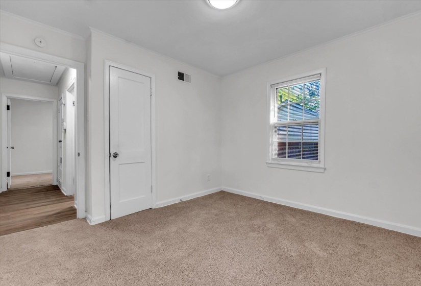 Neutral tone walls complement the light brown carpet flooring