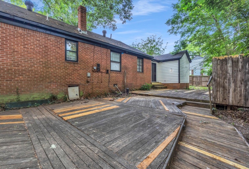 Expansive multi-level wood deck provides outdoor living space