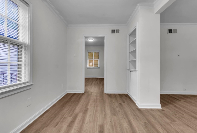 Neutral wall finishes with wood-finish flooring extending throughout