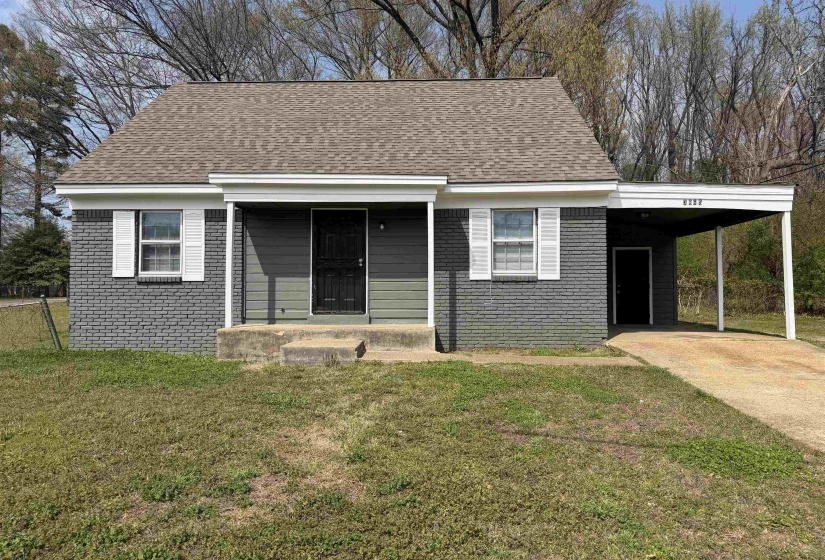 Charming single-story residence with a gray brick exterior and complementary gray siding
