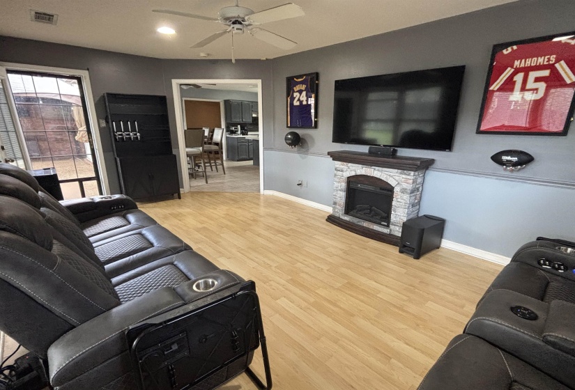 Living area featuring wood-finish flooring and a ceiling fan
