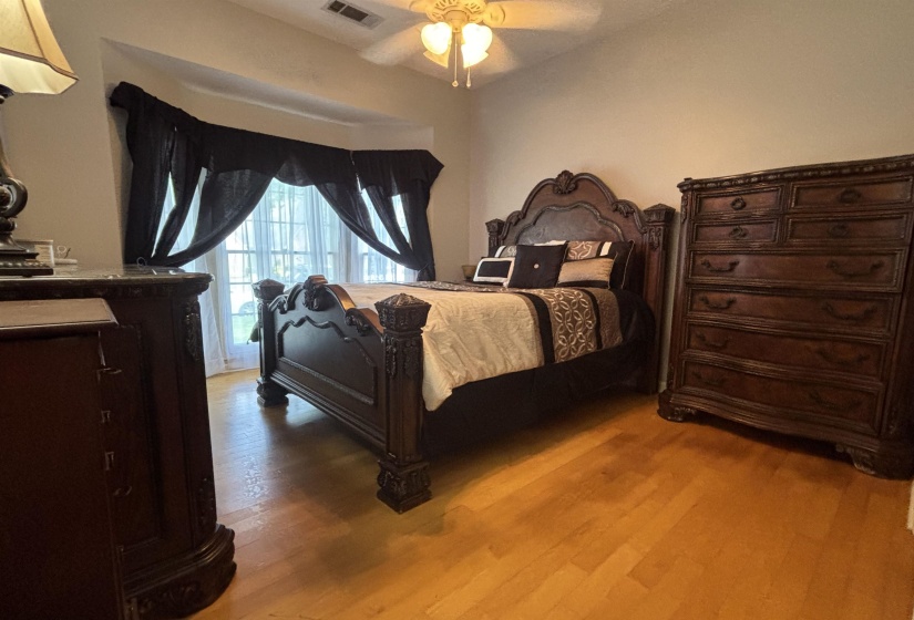 Room featuring light wood-finish flooring and a ceiling fan with integrated lighting
