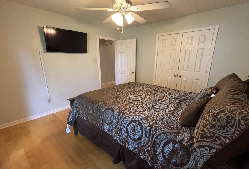 Interior room featuring light-toned walls and wood-finish flooring
