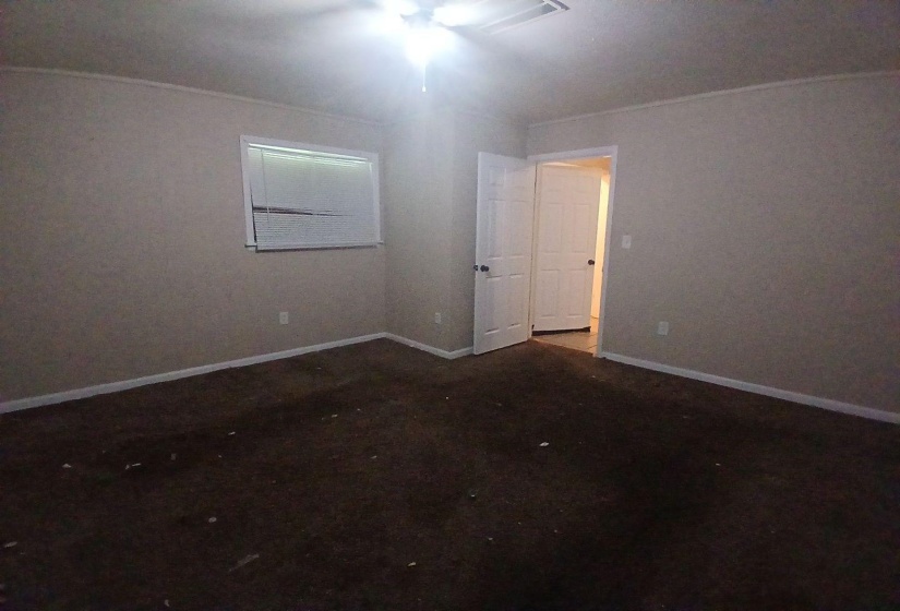 Neutral-toned walls and dark carpet flooring
