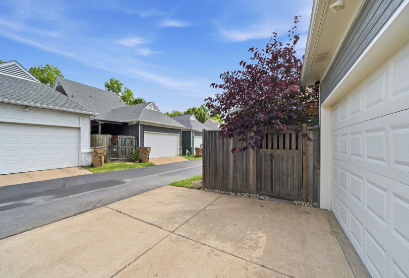 Concrete driveway leading to an attached garage with paneled door