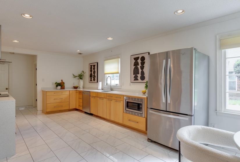 Kitchen featuring light-toned cabinetry, stainless steel appliances, white countertops, and recessed lighting
