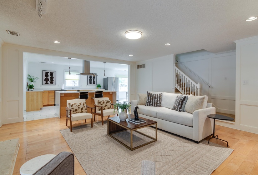 Hardwood flooring throughout the living area, featuring an open concept layout with recessed lighting