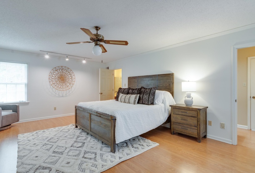 Spacious room featuring light wood-finish flooring and white walls