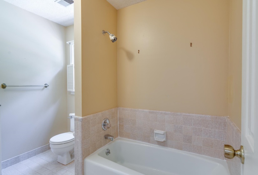 Bathroom featuring a built-in bathtub, separate shower, separate vanities.