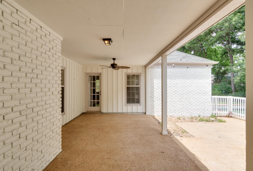 Covered patio featuring an exposed aggregate concrete surface