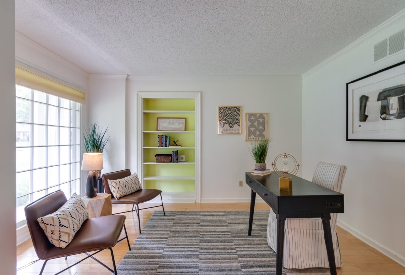 Room featuring light wood-finish flooring, white walls, and crown molding
