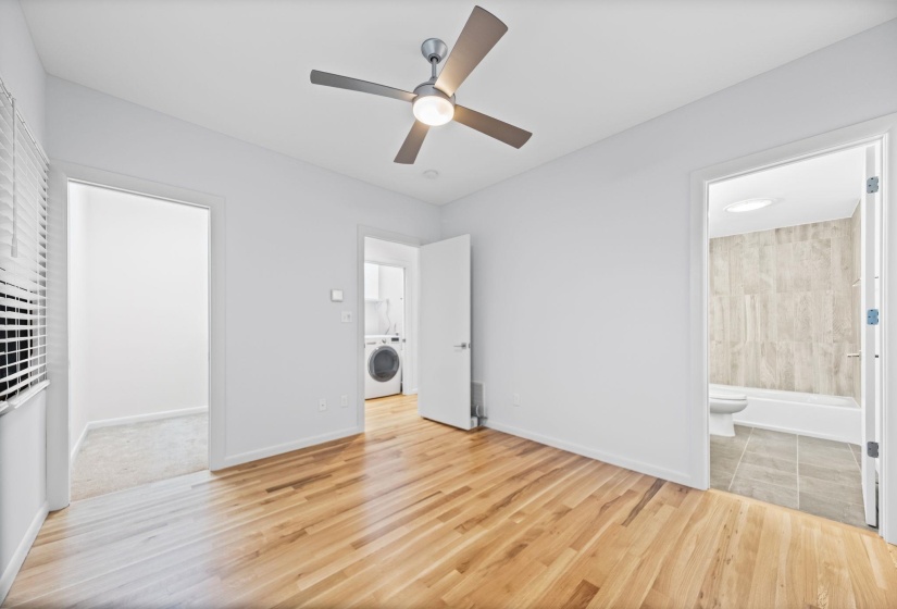 Light wood-finish flooring with a ceiling fan featuring integrated lighting