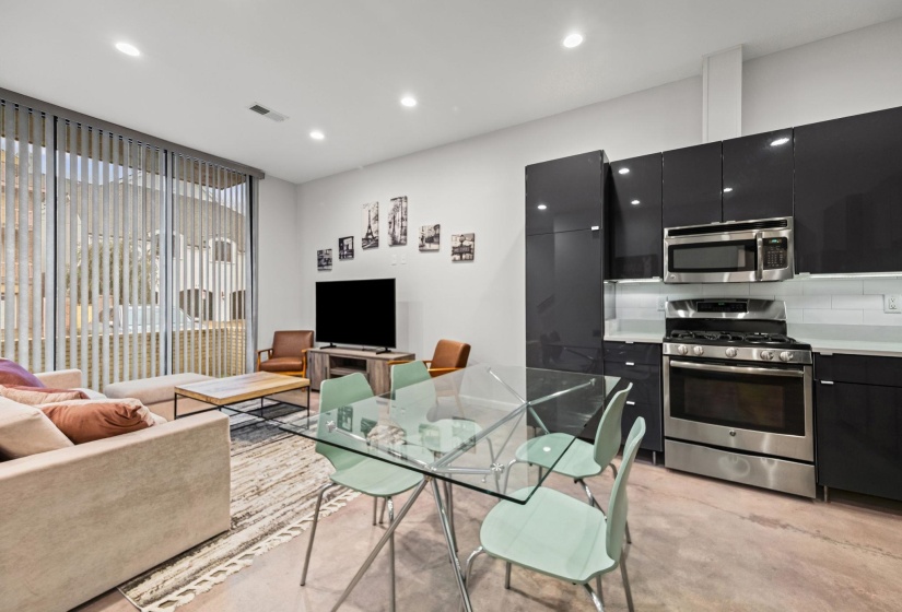 Open-concept living space with concrete-finish flooring