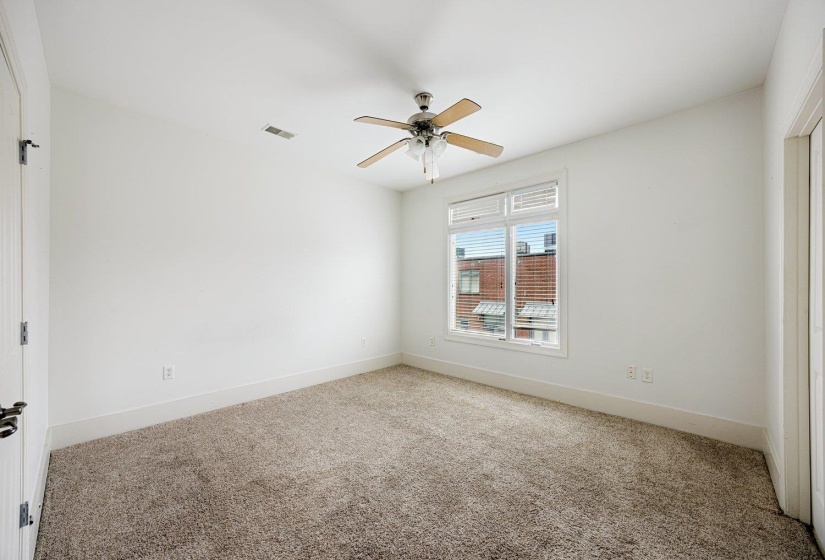 Spare room with carpet floors and a ceiling fan