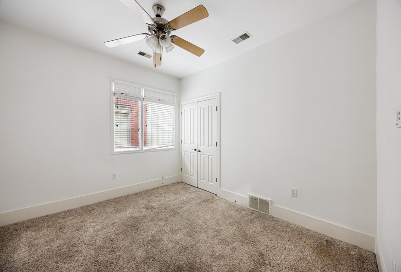 Unfurnished bedroom featuring carpet, a ceiling fan, and a closet