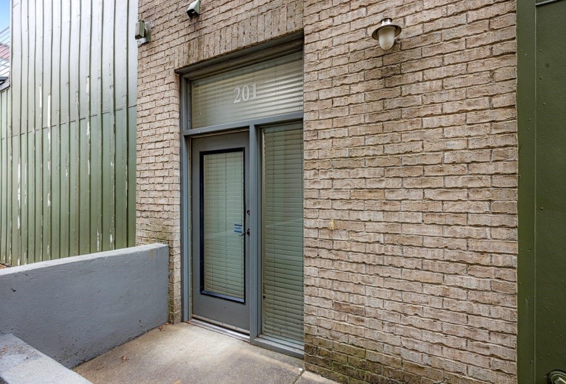 Entrance to property with brick siding