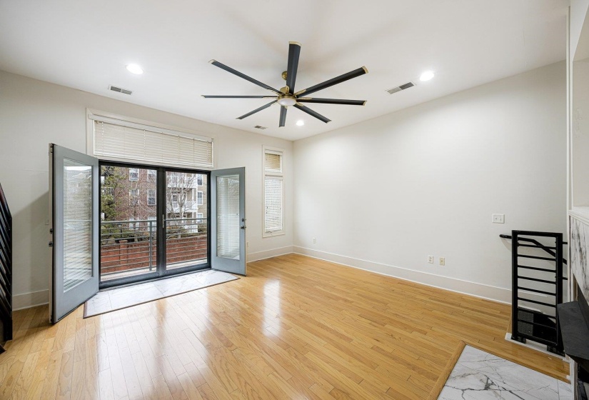 Spare room featuring light wood-type flooring, a ceiling fan, and recessed lighting