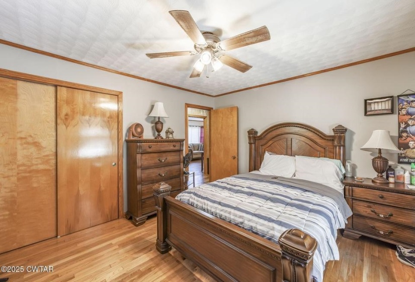 Hardwood flooring, light gray walls, and wood trim create a cohesive aesthetic