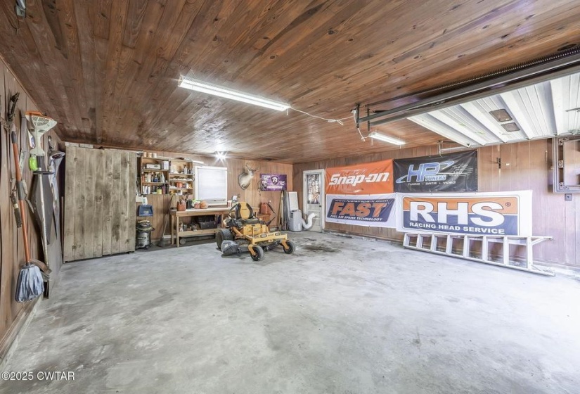 Spacious garage with wood-finish ceiling and walls