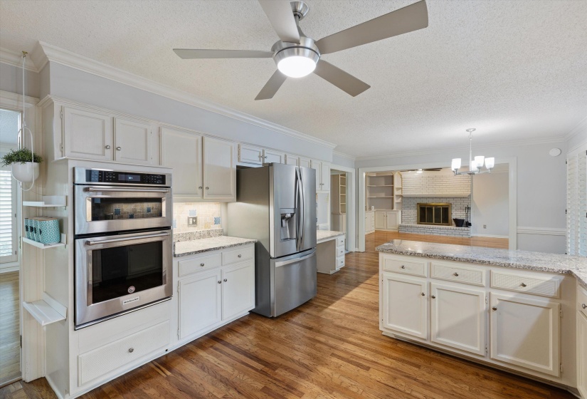 Updated Kitchen w/granite countertops, tumbled marble backsplash, 37 cabinets, 17 drawers, built-in desk, dbl stainless undermount sink, icemaker & stainless KitchenAid appls incl convection oven, MW & 5-burner elec range w/vent-a-hood. Fridge stays