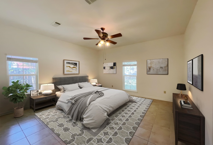 Vaulted ceiling bedroom featuring ceiling fan, dual windows with natural light, and tile flooring