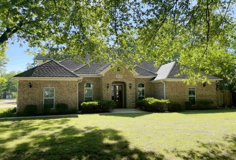 Brick exterior featuring a gabled roofline and multiple window styles