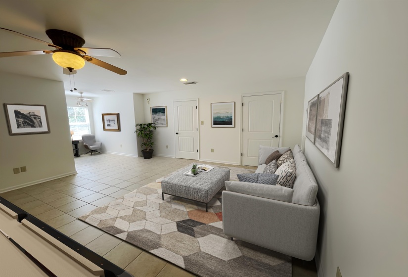 Spacious interior featuring tile flooring, multiple ceiling fans with light fixtures, and white paneled doors
