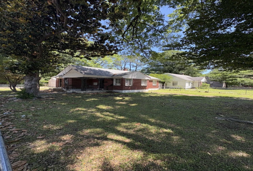 Brick exterior with white siding and a covered front porch