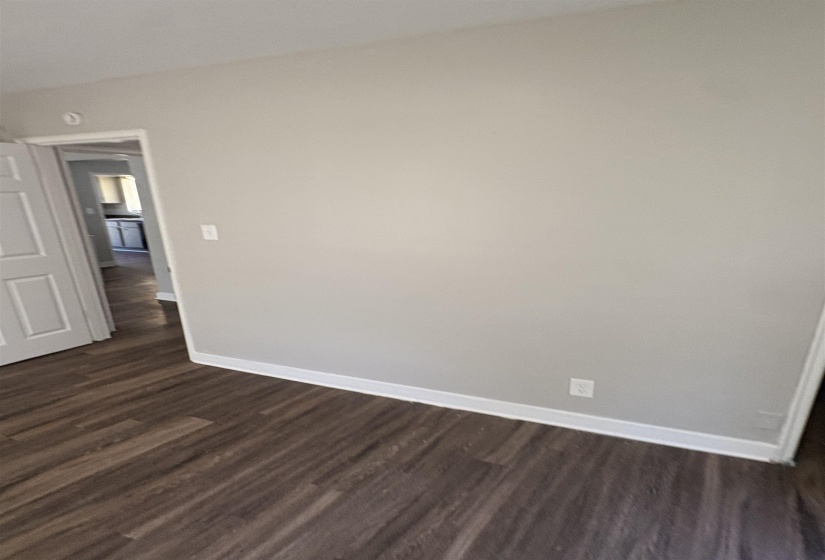 Light gray wall paint with white trim, complemented by wood-finish flooring