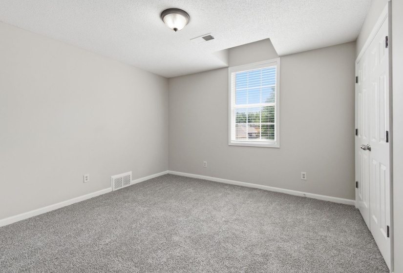 Light gray carpeting with white baseboards throughout
