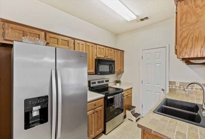 New Oven with smooth surface cooktop, microwave, tile counters, built in shelving/storage, Pantry, Linoleum floor, Refrigerator remains