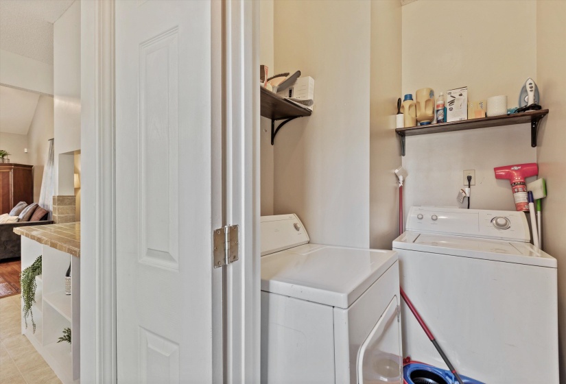 No laundry closet here! French doors open to walk-in Laundry Room with storage