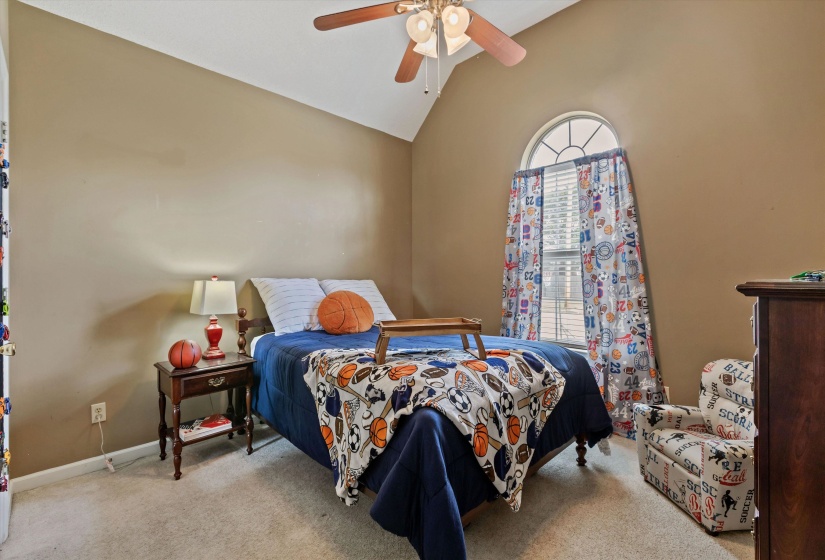 Bedroom 2 with vaulted ceiling, carpet, ceiling fan, closet, shared bath