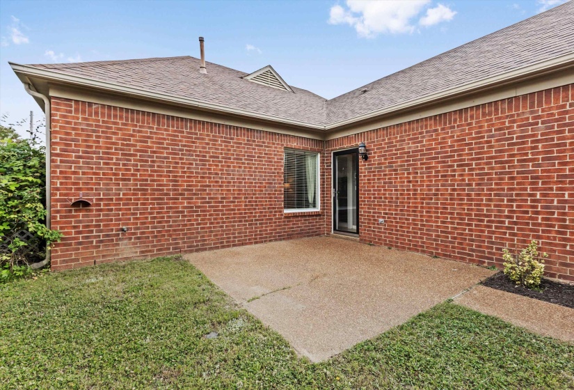 Small fenced and gated yard with concrete patio