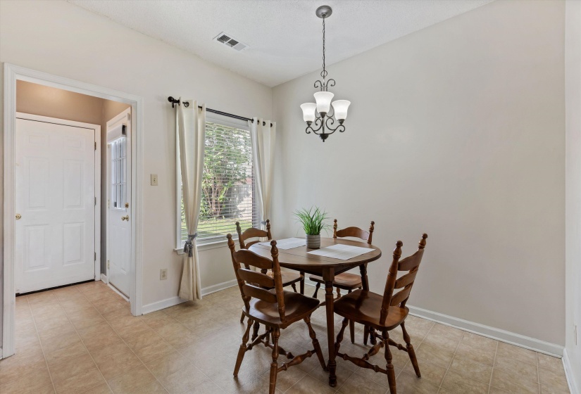 Dine-in Kitchen features brand new window looking out to back paved patio, small fenced yard