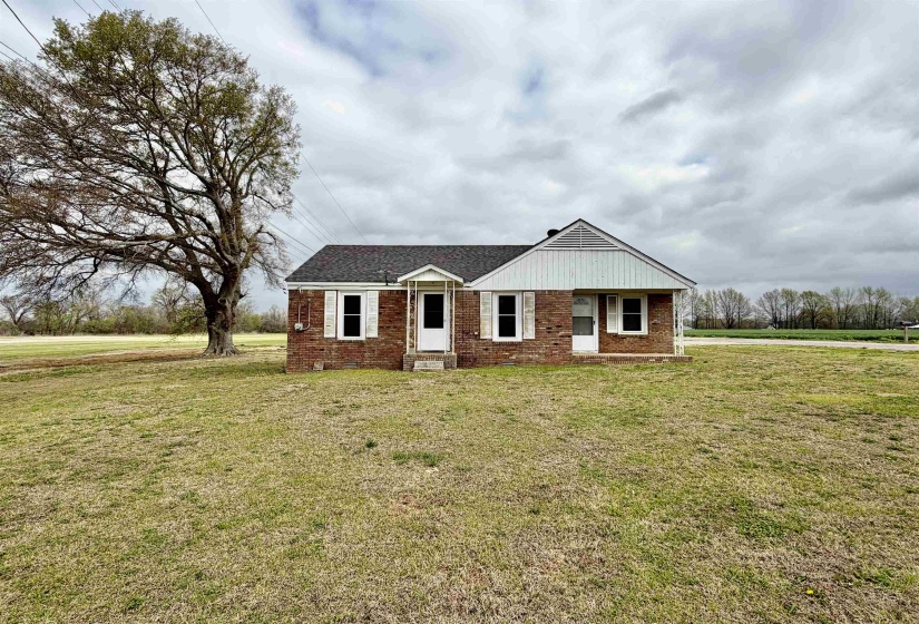View of front of property featuring a front yard and brick siding