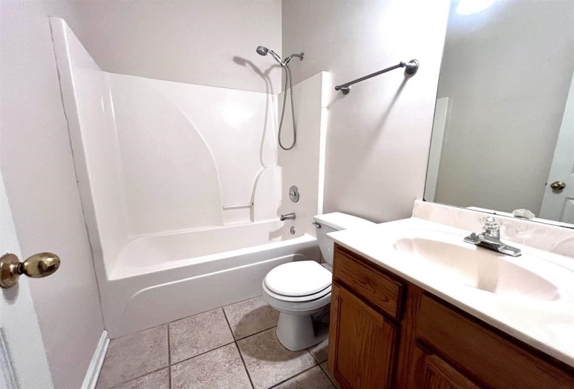 Full bathroom featuring vanity,  shower combination, and light tile patterned floors