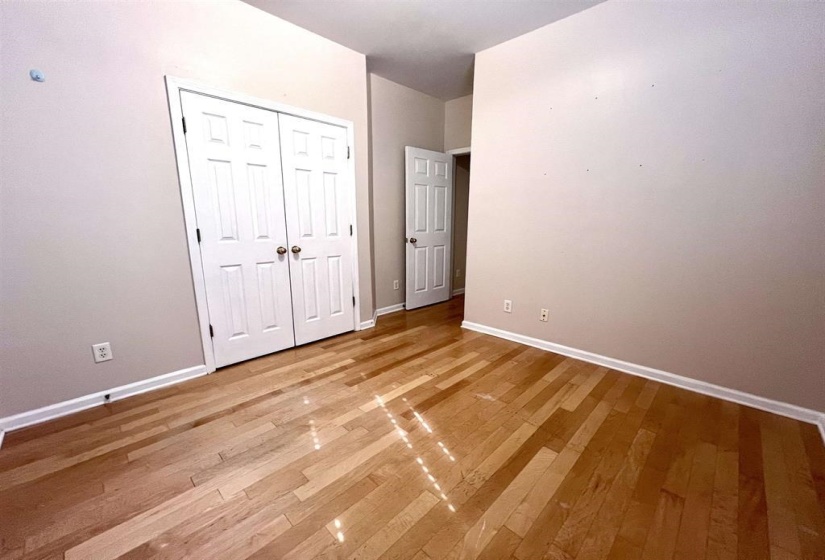 Unfurnished bedroom with light wood-style flooring and a closet