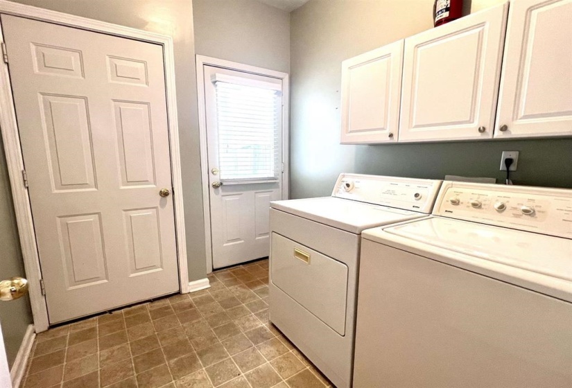 Laundry room featuring washer and clothes dryer and cabinet space