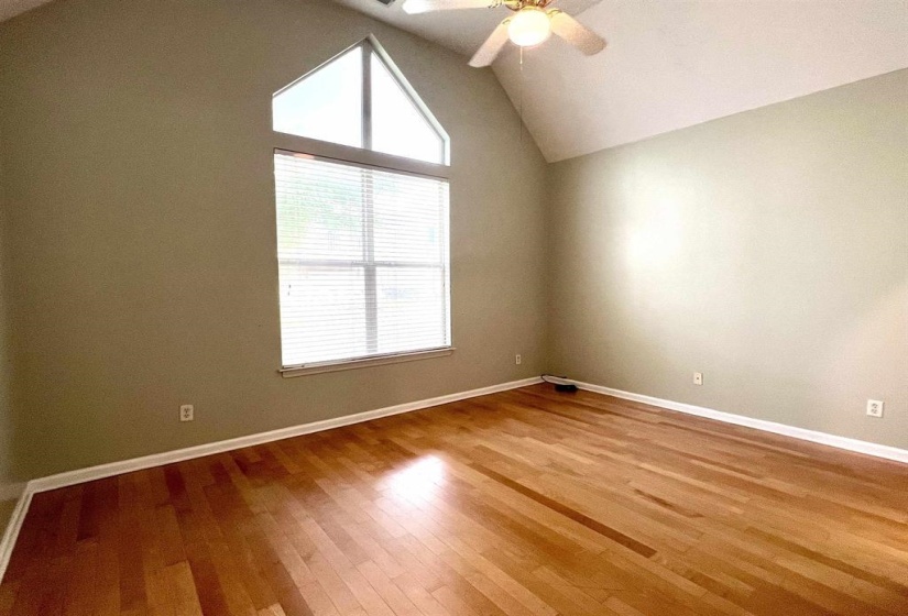 Empty room featuring hardwood / wood-style floors and a ceiling fan