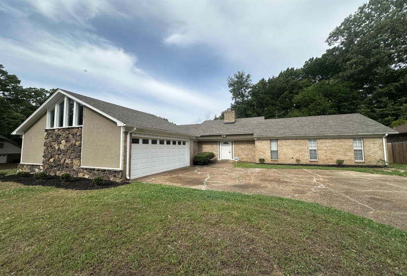 Exterior featuring a combination of brick and stucco siding