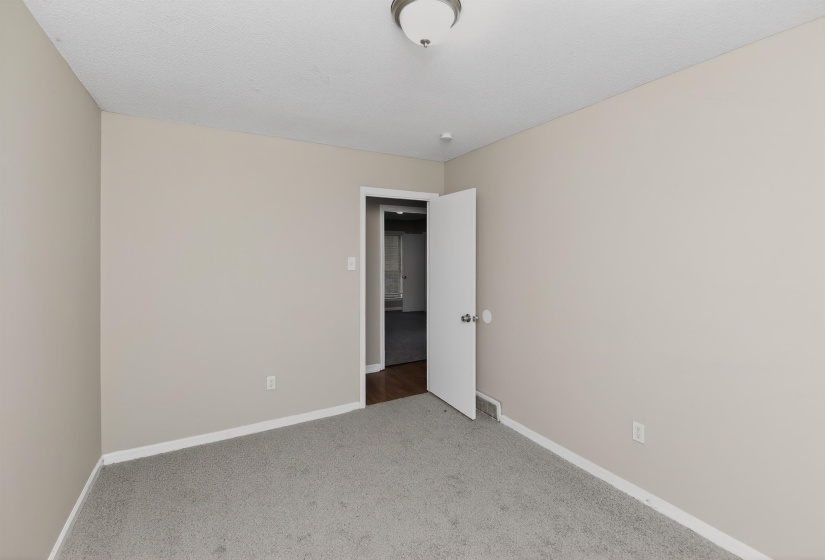Neutral-toned room featuring light gray walls and a complementary gray carpet