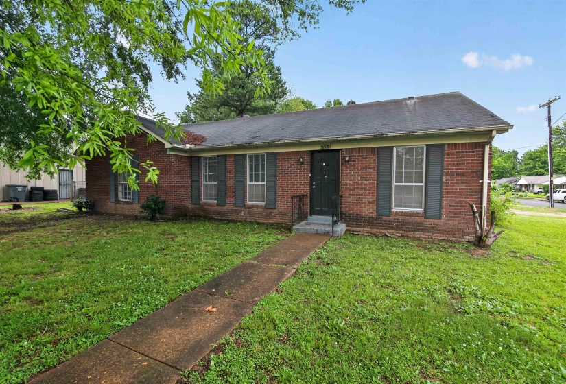 Brick-clad exterior with a dark roofline and coordinating shutters