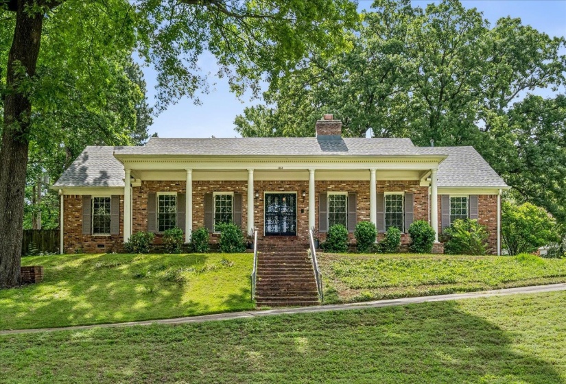 Brick exterior with a covered front porch featuring white columns